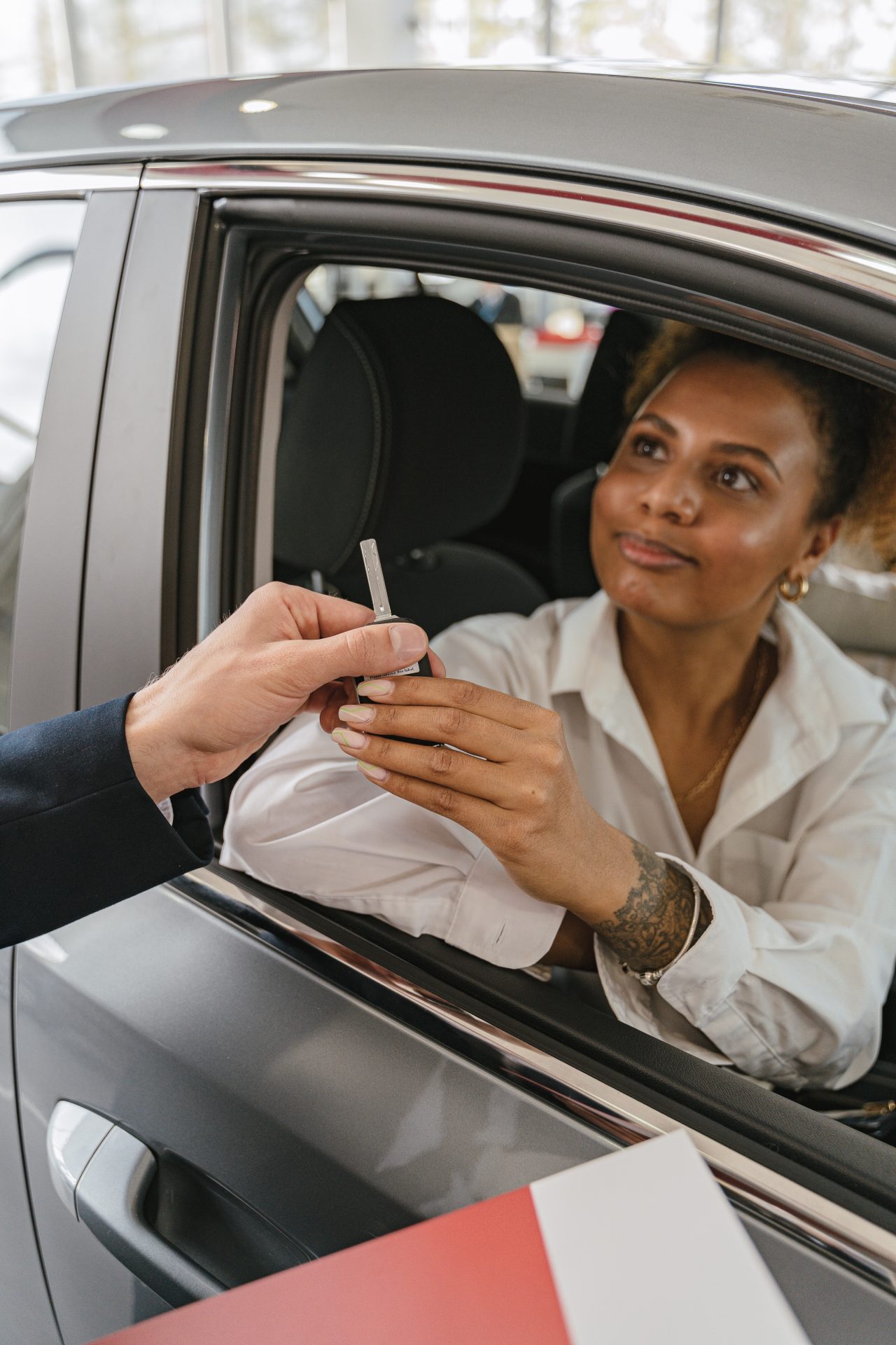 woman handing off key